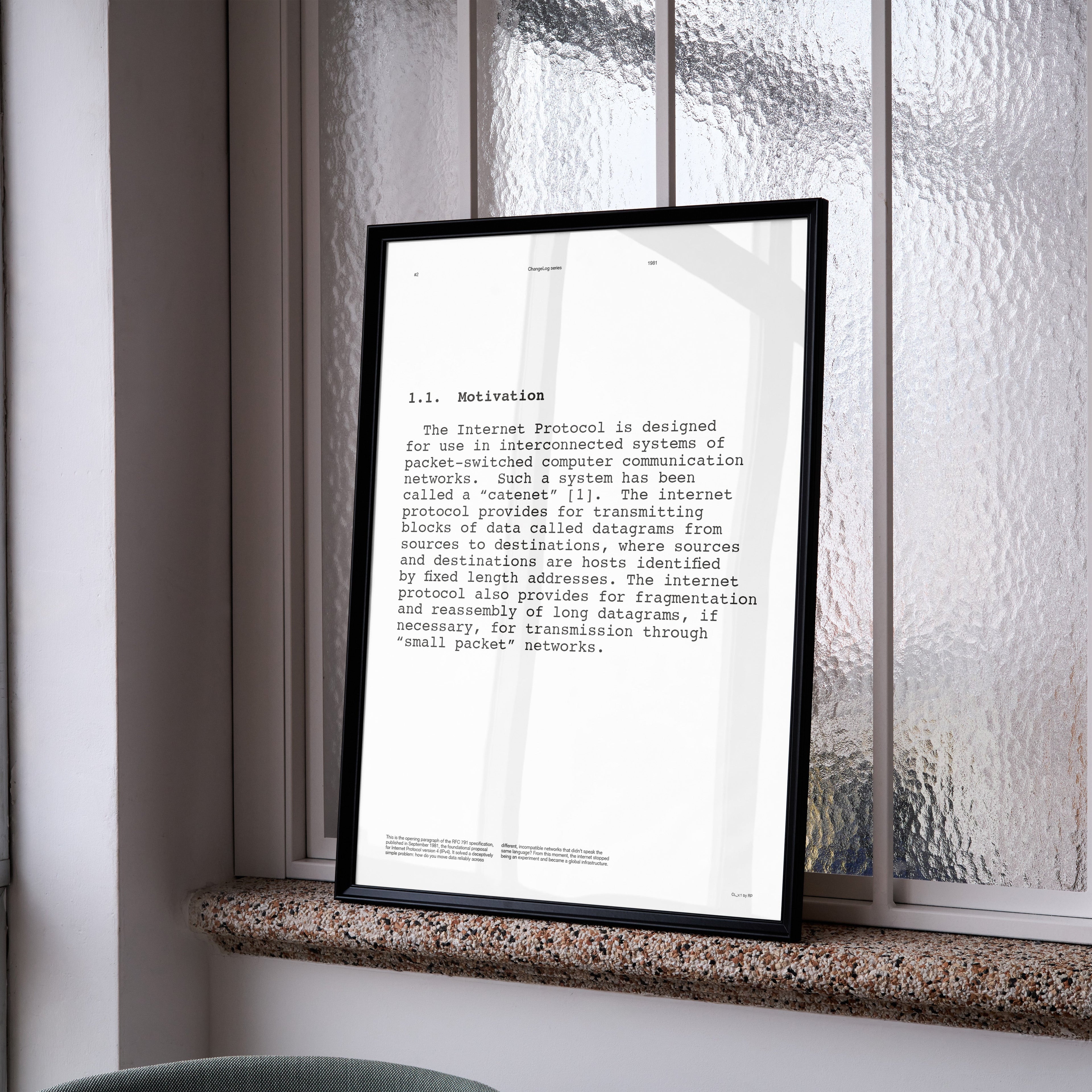 Framed document on a windowsill with a view of buildings outside